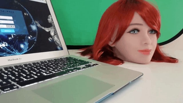A mannequin with red hair provides companionship alongside a laptop equipped with the Emma AI annual subscription.